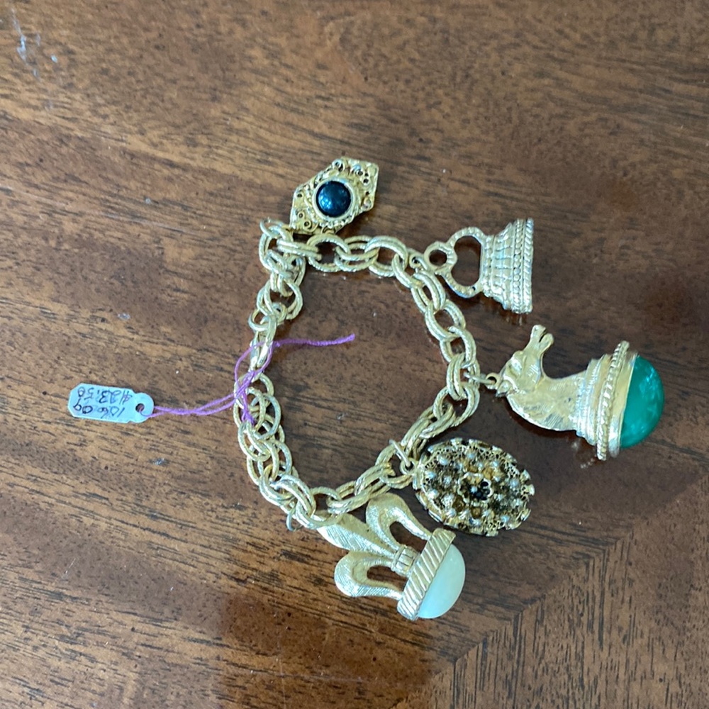 Vintage charm bracelet, gold tone. Approximately 8 inches in length.